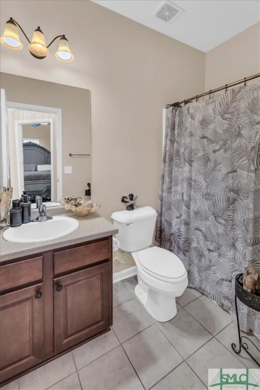 bathroom featuring tile patterned floors, vanity, and toilet