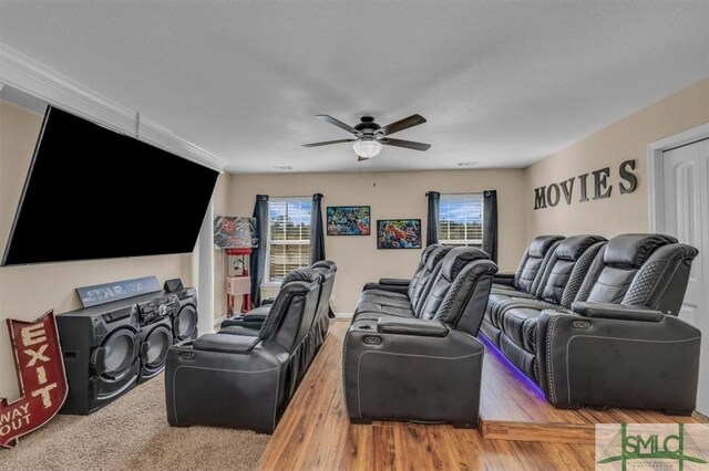 cinema featuring ceiling fan and wood-type flooring