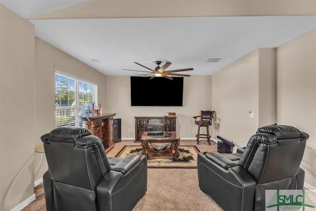 carpeted living room with ceiling fan