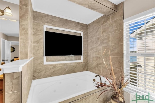 bathroom featuring plenty of natural light and tiled tub