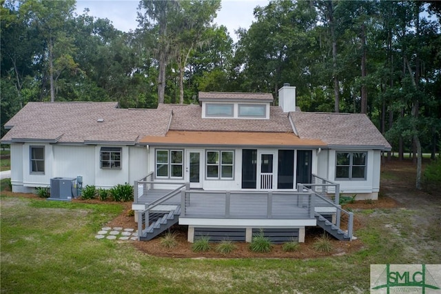 view of front facade with a chimney, stairway, roof with shingles, a front lawn, and central AC