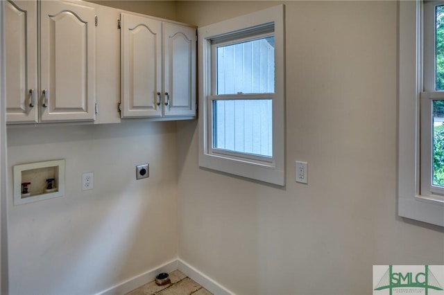 clothes washing area featuring cabinet space, baseboards, hookup for an electric dryer, washer hookup, and a wealth of natural light