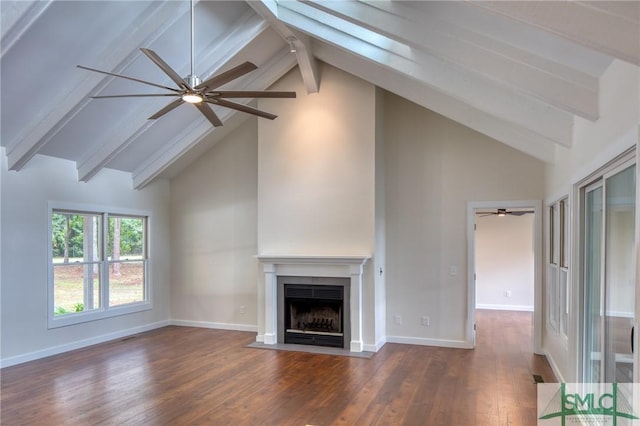 unfurnished living room featuring a fireplace with flush hearth, beam ceiling, baseboards, and wood finished floors