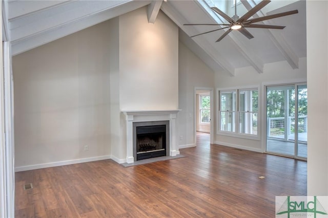 unfurnished living room featuring beam ceiling, a fireplace with flush hearth, wood finished floors, high vaulted ceiling, and baseboards