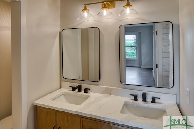 full bath featuring double vanity and a sink