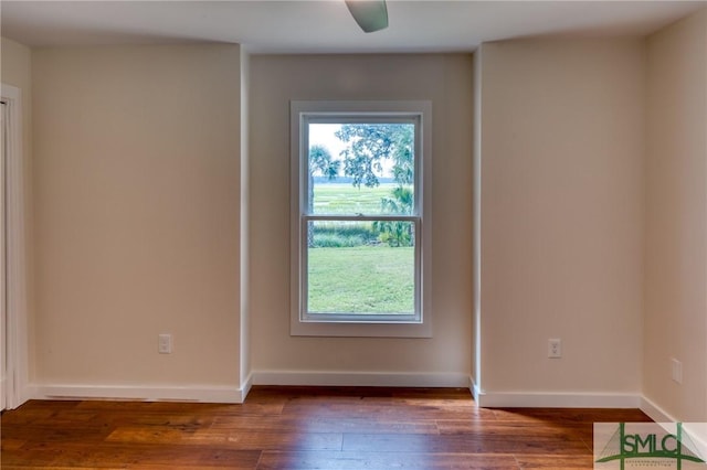 unfurnished room with wood-type flooring and baseboards