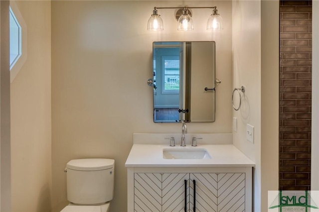 bathroom featuring toilet and vanity