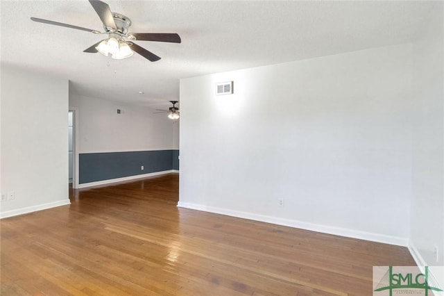 unfurnished room featuring hardwood / wood-style flooring and a textured ceiling