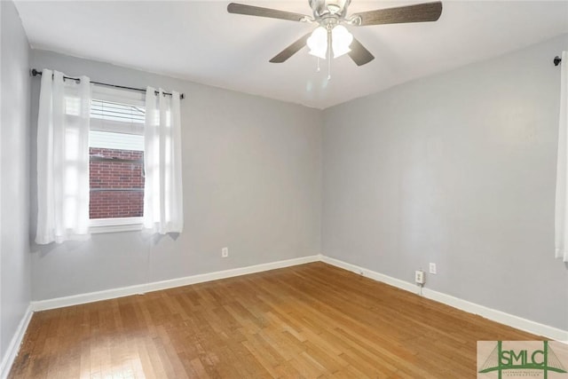 unfurnished room with ceiling fan and hardwood / wood-style flooring