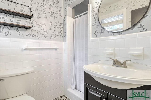 bathroom with vanity, toilet, tile walls, and curtained shower