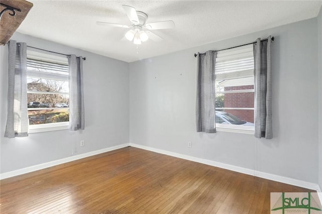 unfurnished room featuring ceiling fan, wood-type flooring, and a textured ceiling