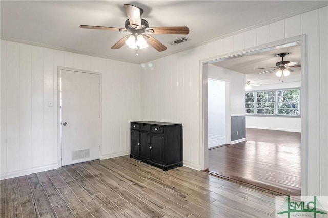 unfurnished room with hardwood / wood-style floors and ornamental molding