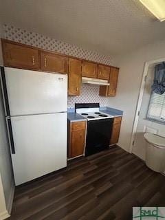 kitchen with dark wood-type flooring and white appliances