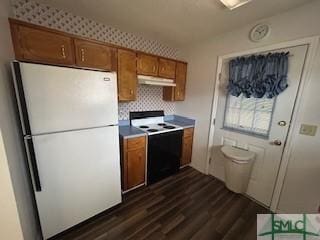 kitchen with decorative backsplash, dark hardwood / wood-style floors, and white appliances