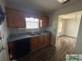 kitchen with decorative backsplash, sink, dark hardwood / wood-style floors, and an inviting chandelier