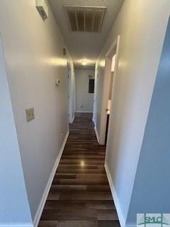 hallway with dark wood-type flooring