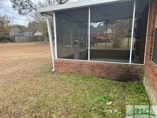 view of yard featuring a sunroom