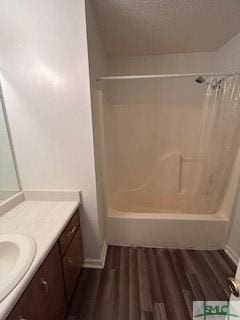 bathroom with shower / tub combo, vanity, and hardwood / wood-style flooring