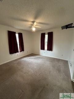 spare room featuring carpet flooring, ceiling fan, and a textured ceiling