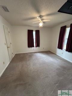 unfurnished bedroom with carpet flooring, ceiling fan, and a textured ceiling