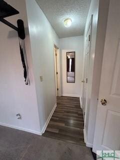 hall featuring a textured ceiling