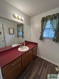 bathroom featuring hardwood / wood-style floors, vanity, and a textured ceiling