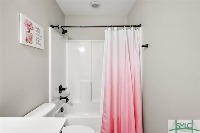 bathroom with toilet and shower / tub combo