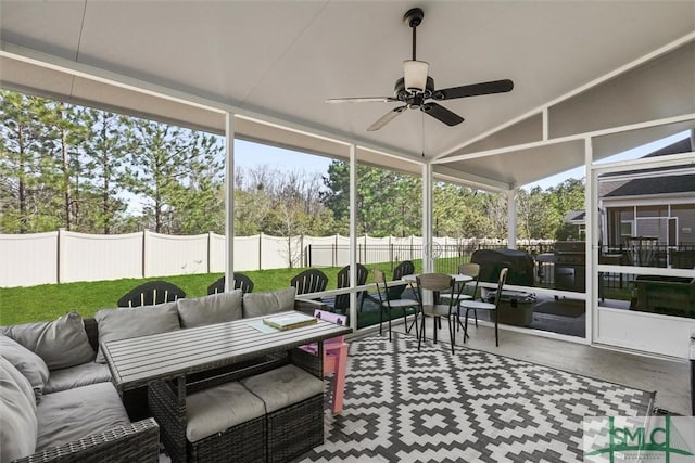 sunroom featuring ceiling fan