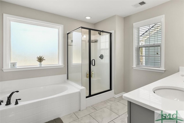 bathroom featuring tile patterned flooring, vanity, and plus walk in shower