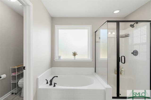 bathroom with tile patterned floors, toilet, and independent shower and bath