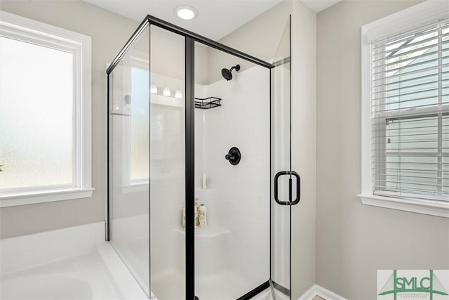 bathroom featuring a shower with door