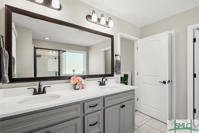 bathroom with vanity, tile patterned floors, and a shower with shower door