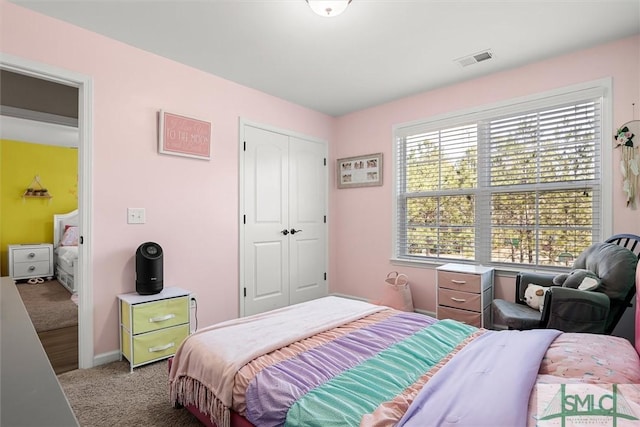 carpeted bedroom featuring a closet