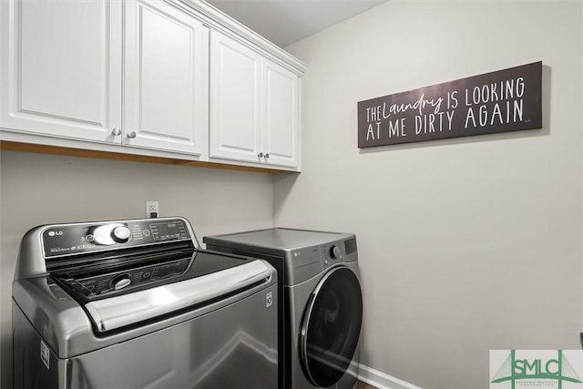 laundry area featuring cabinets and separate washer and dryer