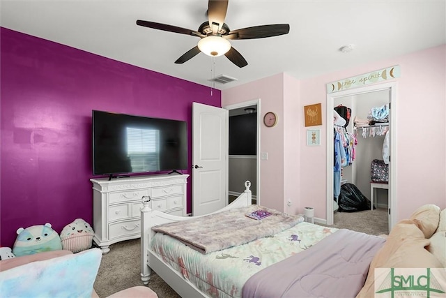 carpeted bedroom with ceiling fan and a closet