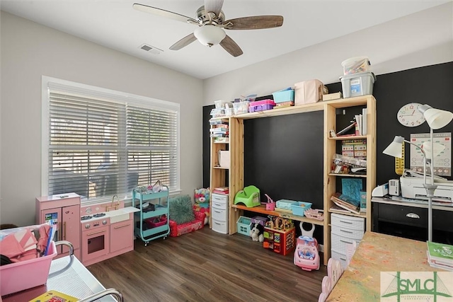 rec room with ceiling fan and dark hardwood / wood-style floors