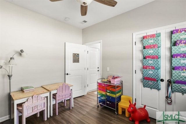 rec room featuring ceiling fan and dark wood-type flooring