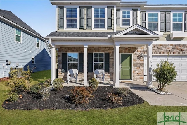 view of exterior entry featuring a porch and a garage