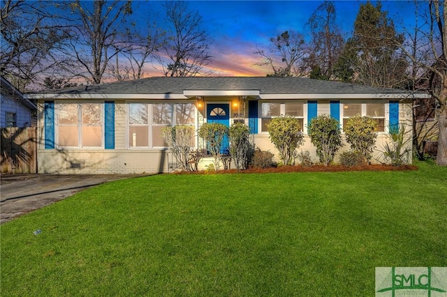 ranch-style home featuring a lawn