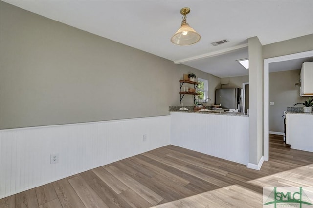 unfurnished dining area featuring light hardwood / wood-style flooring