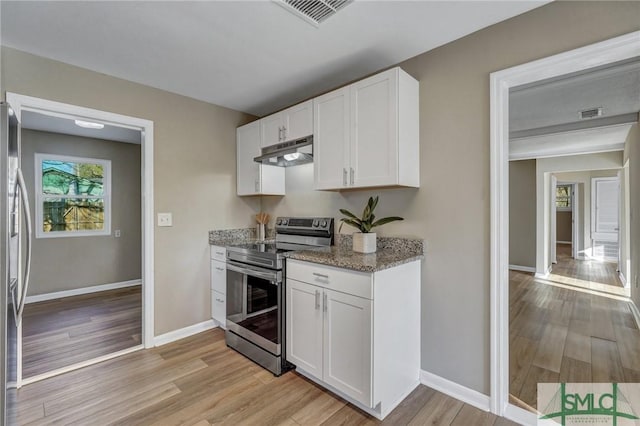 kitchen featuring white cabinets, light hardwood / wood-style floors, light stone counters, and stainless steel appliances