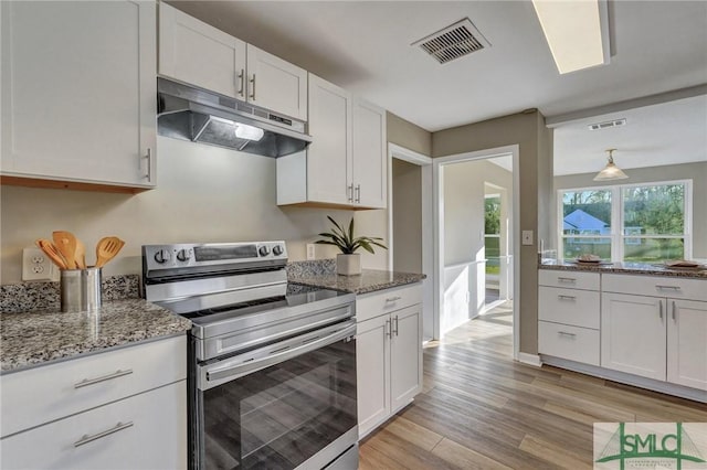 kitchen featuring light wood-type flooring, pendant lighting, stone countertops, white cabinets, and stainless steel range with electric cooktop