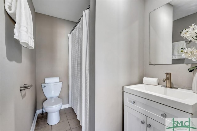 bathroom featuring tile patterned flooring, vanity, and toilet