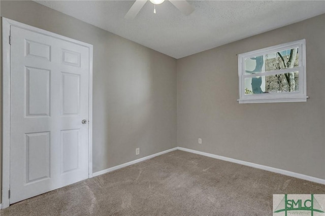 unfurnished room with ceiling fan and light colored carpet