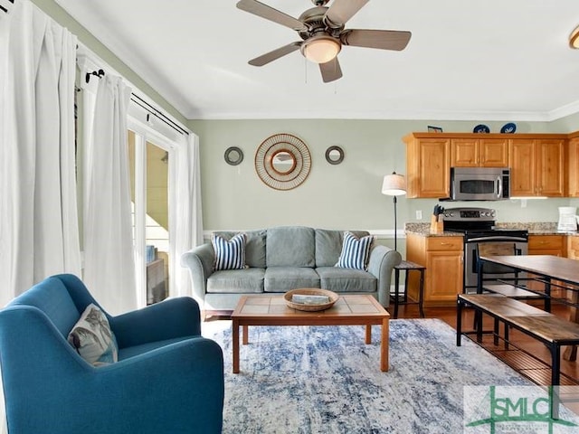 living room featuring ceiling fan, wood-type flooring, and ornamental molding