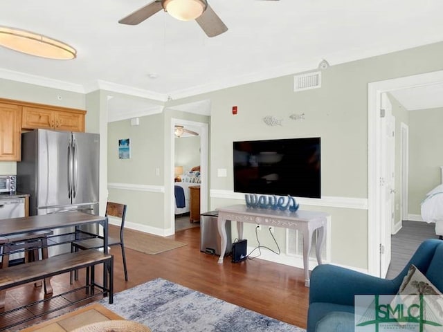 living room featuring dark hardwood / wood-style floors and ornamental molding