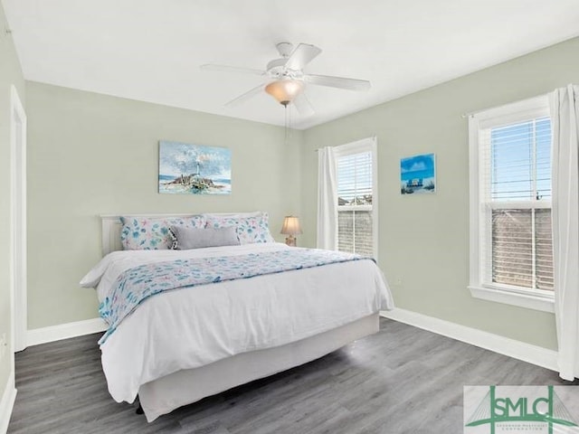 bedroom with ceiling fan and dark hardwood / wood-style flooring