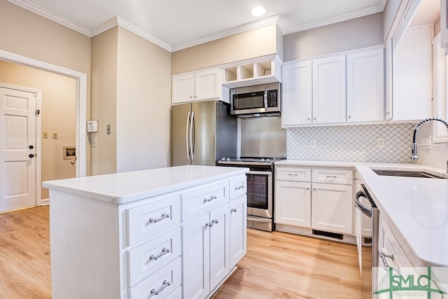 kitchen with white cabinetry, sink, a center island, and appliances with stainless steel finishes