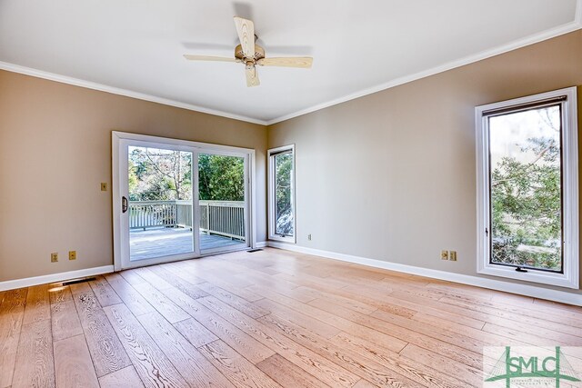 empty room featuring ceiling fan, ornamental molding, and light hardwood / wood-style flooring