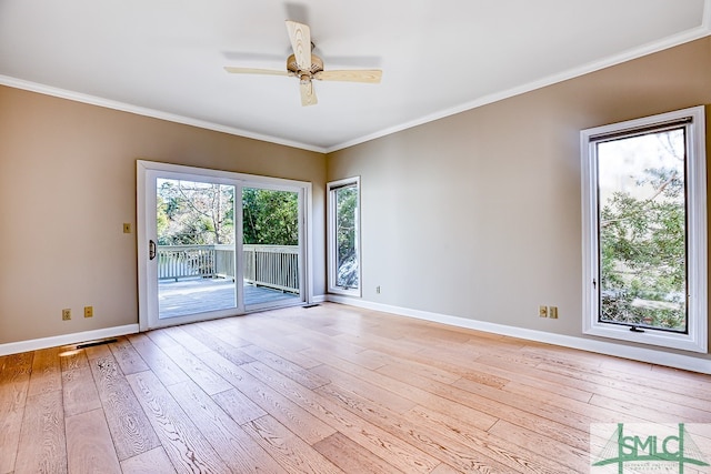 spare room featuring baseboards, light wood-style floors, and crown molding